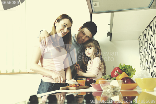 Image of happy young family in kitchen