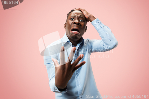 Image of Beautiful man looking suprised and bewildered isolated on pink