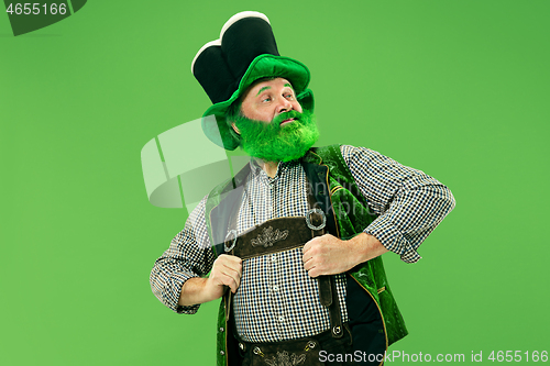 Image of A man in a leprechaun hat at studio. He celebrates St. Patrick\'s Day.