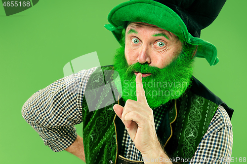 Image of A man in a leprechaun hat at studio. He celebrates St. Patrick\'s Day.