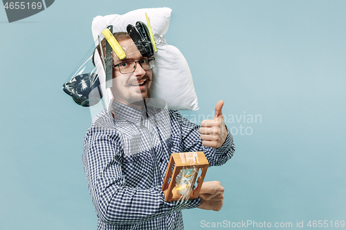 Image of Tired man sleeping at home having too much work. Bored businessman with pillow