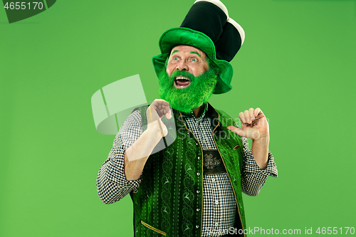 Image of A man in a leprechaun hat at studio. He celebrates St. Patrick\'s Day.