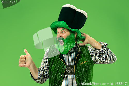 Image of A man in a leprechaun hat at studio. He celebrates St. Patrick\'s Day.