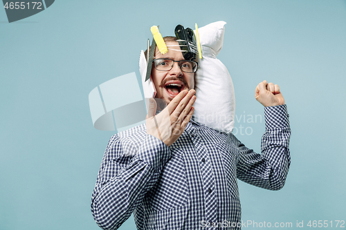 Image of Tired man sleeping at home having too much work. Bored businessman with pillow