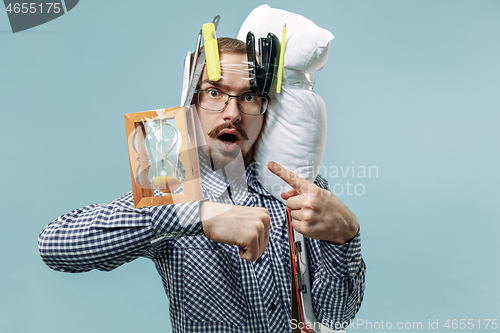 Image of Tired man sleeping at home having too much work. Bored businessman with pillow