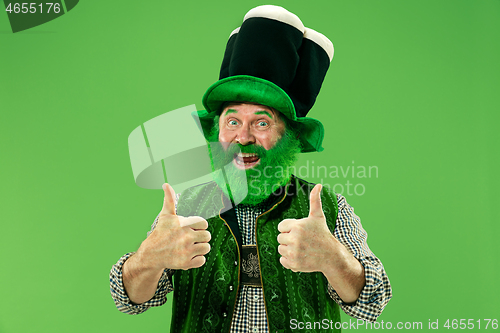 Image of A man in a leprechaun hat at studio. He celebrates St. Patrick\'s Day.