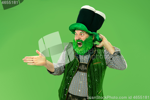 Image of A man in a leprechaun hat at studio. He celebrates St. Patrick\'s Day.