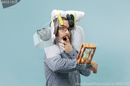 Image of Tired man sleeping at home having too much work. Bored businessman with pillow