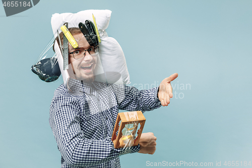 Image of Tired man sleeping at home having too much work. Bored businessman with pillow