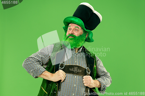 Image of A man in a leprechaun hat at studio. He celebrates St. Patrick\'s Day.