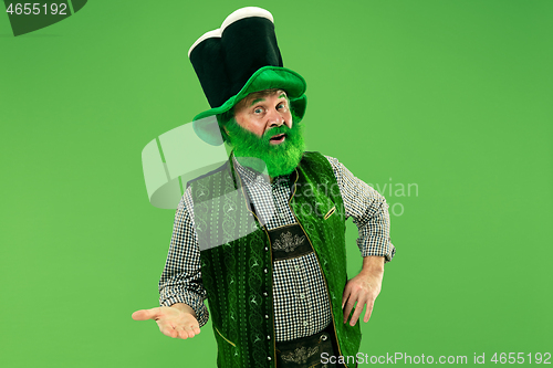 Image of A man in a leprechaun hat at studio. He celebrates St. Patrick\'s Day.