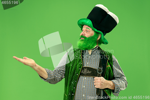 Image of A man in a leprechaun hat at studio. He celebrates St. Patrick\'s Day.