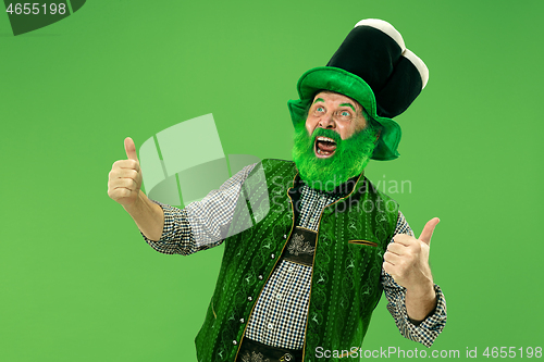 Image of A man in a leprechaun hat at studio. He celebrates St. Patrick\'s Day.