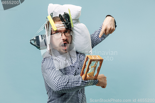 Image of Tired man sleeping at home having too much work. Bored businessman with pillow