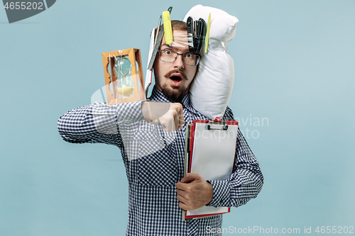 Image of Tired man sleeping at home having too much work. Bored businessman with pillow