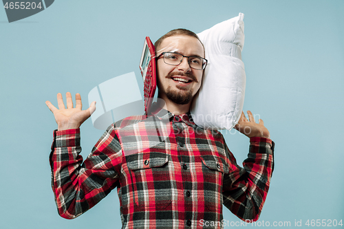 Image of Tired man sleeping at home having too much work. Bored businessman with pillow