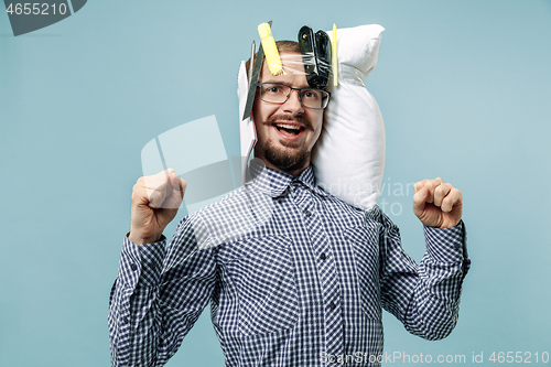 Image of Tired man sleeping at home having too much work. Bored businessman with pillow