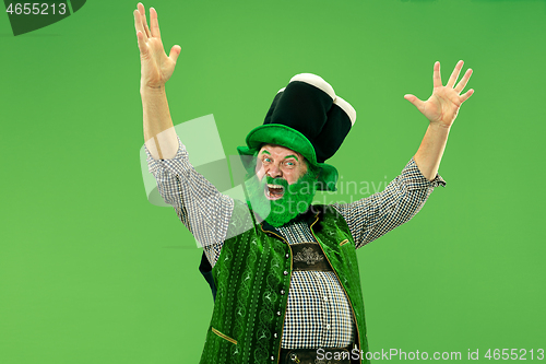 Image of A man in a leprechaun hat at studio. He celebrates St. Patrick\'s Day.