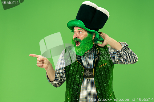 Image of A man in a leprechaun hat at studio. He celebrates St. Patrick\'s Day.