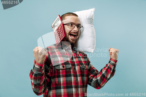 Image of Tired man sleeping at home having too much work. Bored businessman with pillow