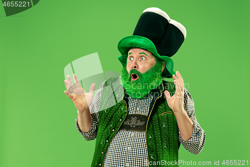 Image of A man in a leprechaun hat at studio. He celebrates St. Patrick\'s Day.