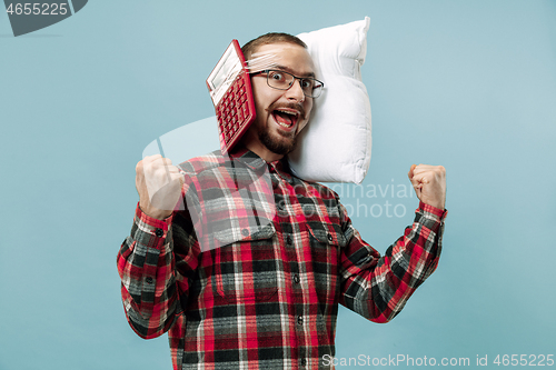 Image of Tired man sleeping at home having too much work. Bored businessman with pillow