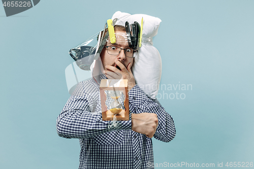 Image of Tired man sleeping at home having too much work. Bored businessman with pillow