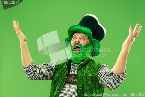 Image of A man in a leprechaun hat at studio. He celebrates St. Patrick\'s Day.