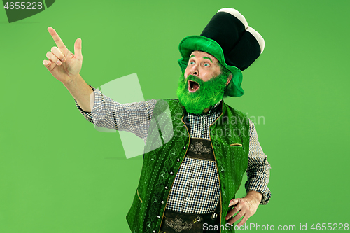 Image of A man in a leprechaun hat at studio. He celebrates St. Patrick\'s Day.