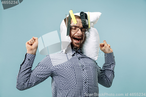 Image of Tired man sleeping at home having too much work. Bored businessman with pillow