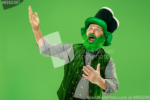 Image of A man in a leprechaun hat at studio. He celebrates St. Patrick\'s Day.