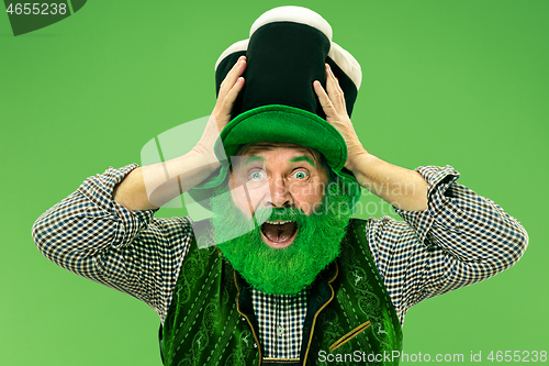 Image of A man in a leprechaun hat at studio. He celebrates St. Patrick\'s Day.