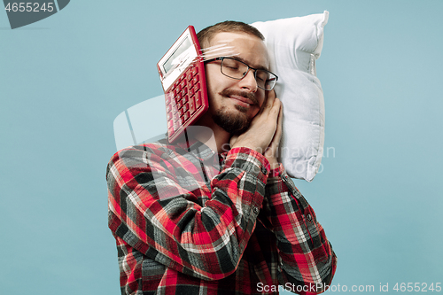 Image of Tired man sleeping at home having too much work. Bored businessman with pillow