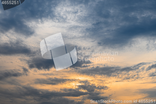 Image of Blue, yellow and orange sunset with clouds