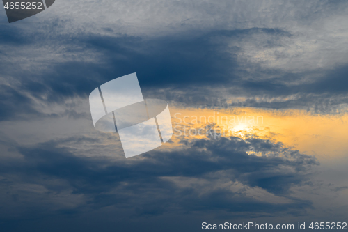 Image of Blue, yellow and orange sunset with clouds