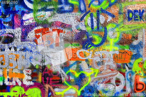 Image of Detail of bright colorful John Lennon's wall with graffiti in Pr