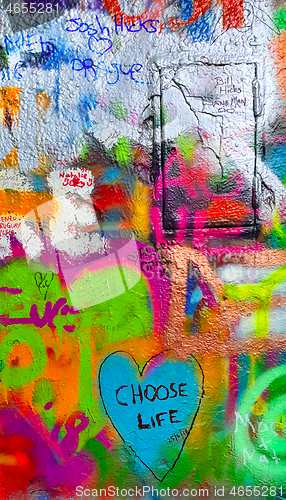 Image of Detail of bright colorful John Lennon's wall with graffiti in Pr