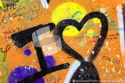 Image of Detail of bright colorful John Lennon's wall with graffiti in Pr