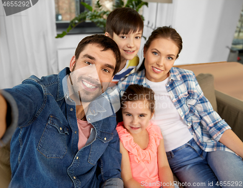 Image of happy family taking selfie at home