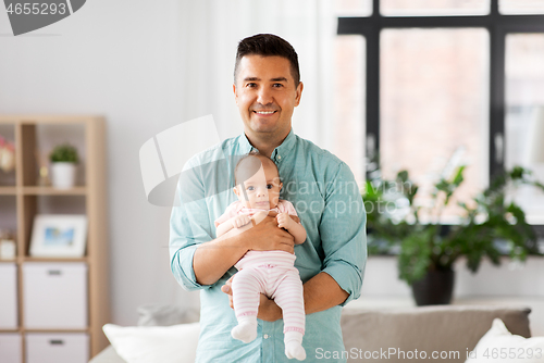 Image of middle aged father with baby daughter at home