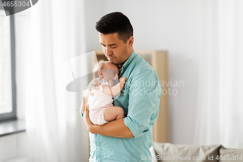 Image of middle aged father with baby daughter at home