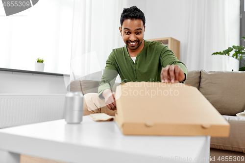 Image of indian man looking inside of takeaway pizza box