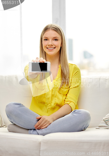 Image of young woman or teen girl with smartphone at home