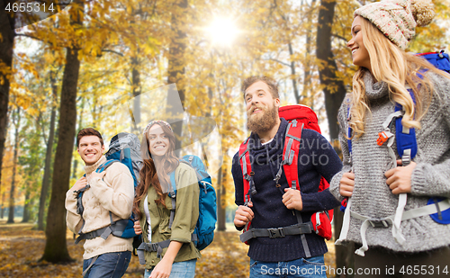 Image of friends with backpacks hiking in autumn