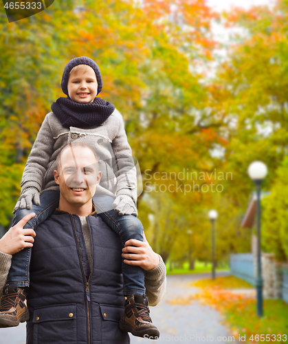 Image of happy family having fun in autumn park