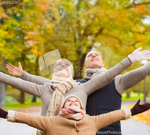 Image of happy family having fun in autumn park