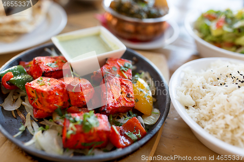 Image of close up of paneer tikka dish with sauce on table