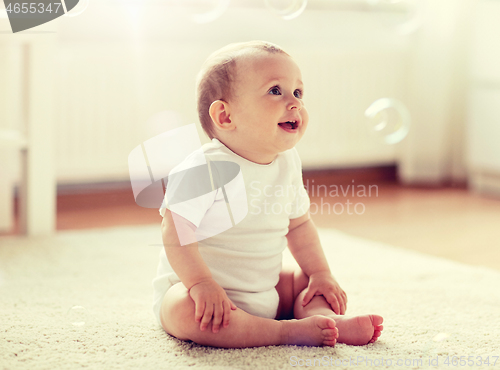 Image of happy baby with soap bubbles at home