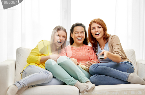 Image of teenage girls or friends watching tv at home