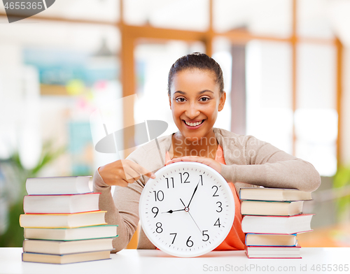 Image of african american student with clock and books